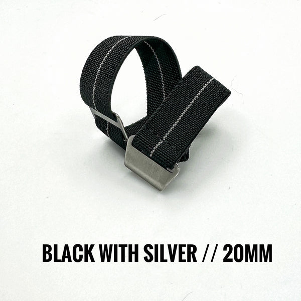 Black strap with silver buckle on a white background with silver stripe paratrooper style band