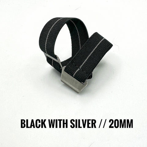 Black strap with silver buckle on a white background with silver stripe paratrooper style band
