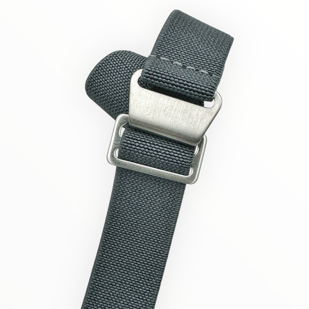 A solid steel blue elastic watch strap with brushed steel hardware and a hook and loop fastening system.