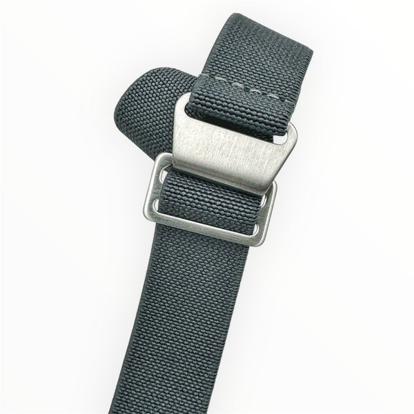 A solid steel blue elastic watch strap with brushed steel hardware and a hook and loop fastening system.